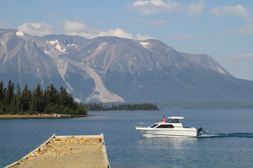 A boat leaves Atlin for a day on Atlin Lake