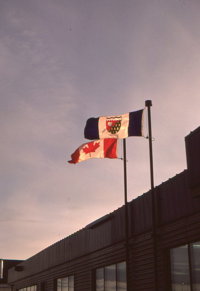 The Midnight Sun lights up the flags on the terminal at the Inuvik airport on June 21