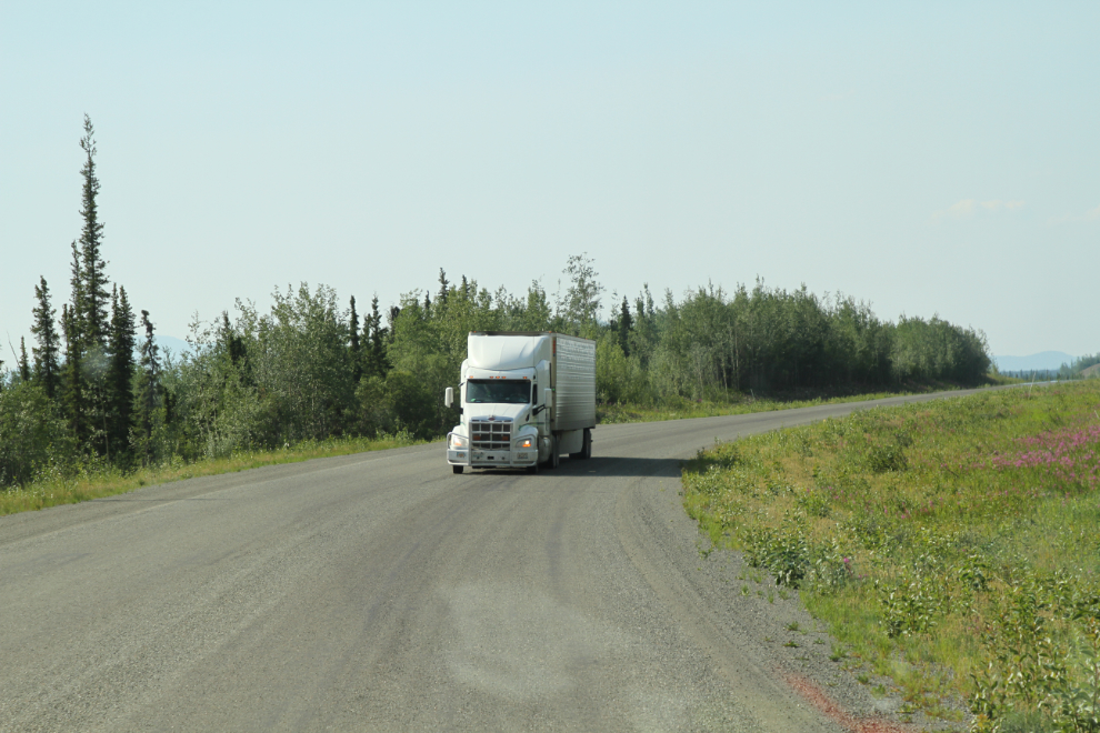 A semi backing up along the Alaska Highway to escape the Snag wildfire, Yukon