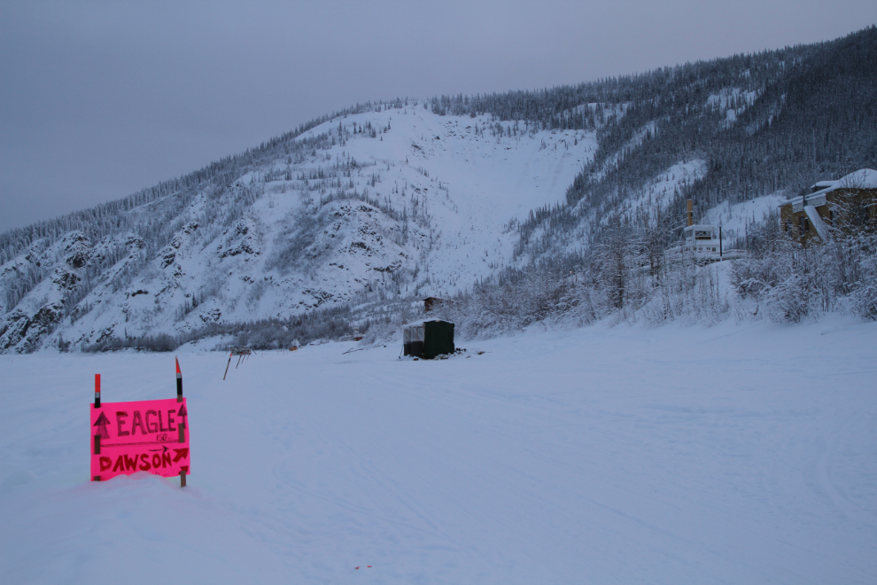 A directional sign on the Yukon Quest 2019 trail at Dawson City