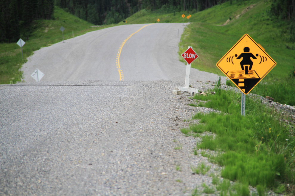 Gravel road warning sign for motorcycles on the Alaska Highway