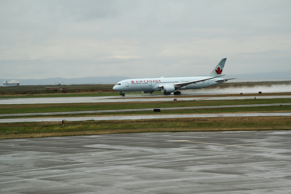 Air Canada Dreamliner C-FGDT throwing up a good spray on her takeoff run at YVR