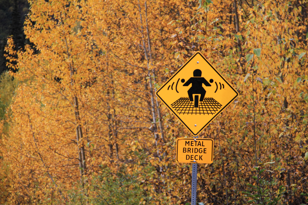 Metal bridge deck warning sign for motorcycles on the Alaska Highway