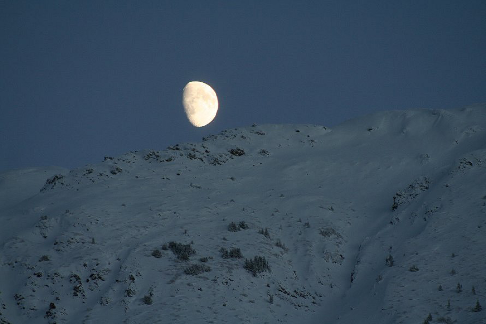 The moon over snowy Yukon peaks