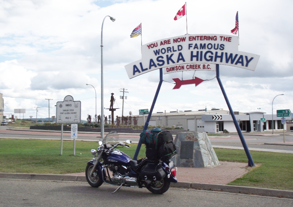 Motorcycle at Mile 0 of the Alaska Highway