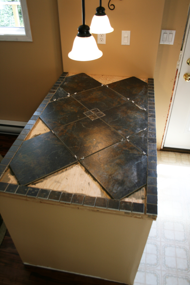 House renovations - laying tile on a serving bar