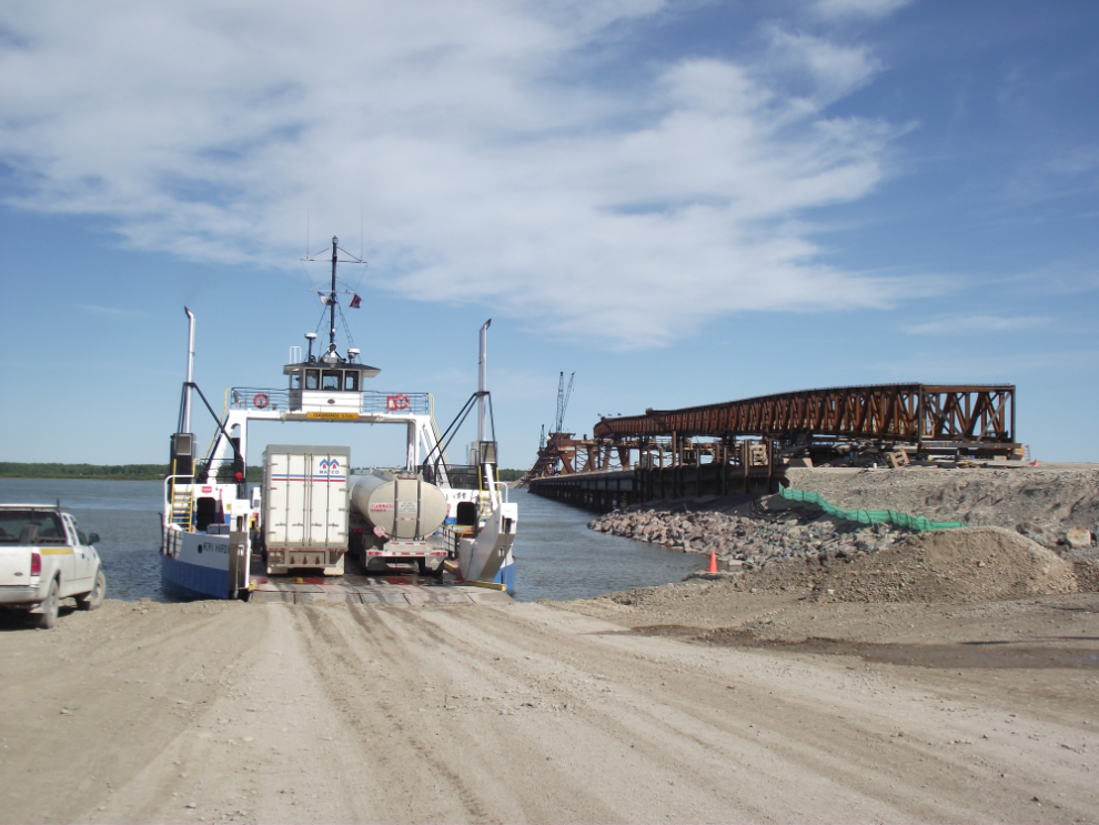 Mackenzie River ferry, and the Deh Cho Bridge under construction, 2011
