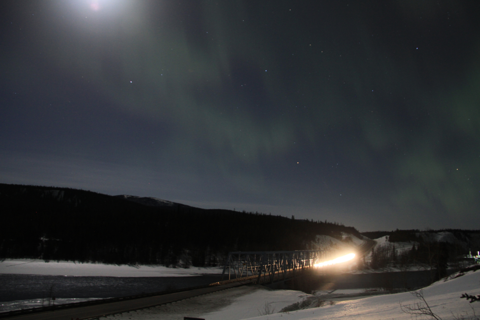 A car coming across the Yukon River Bridge on the Alaska Highway at night
