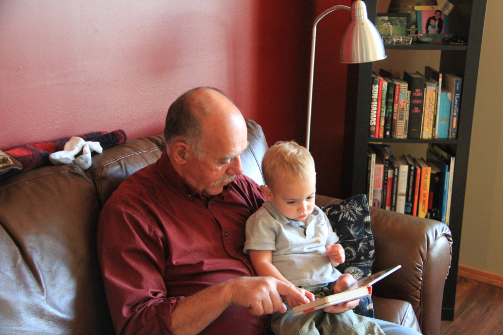Murray reading a book to his grandson