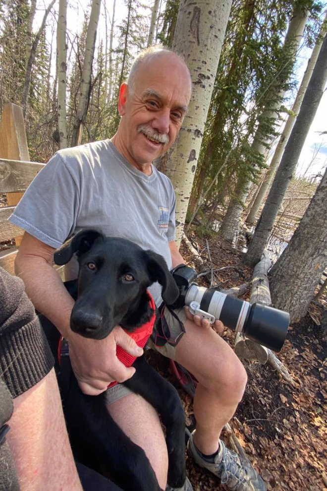 Murray Lundberg with foster puppy Mia at Paddy's Pond in Whitehorse