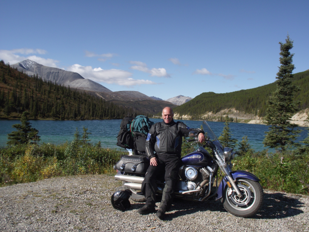 Murray Lundberg with his motorcycle at Summit Lake on the Alcan