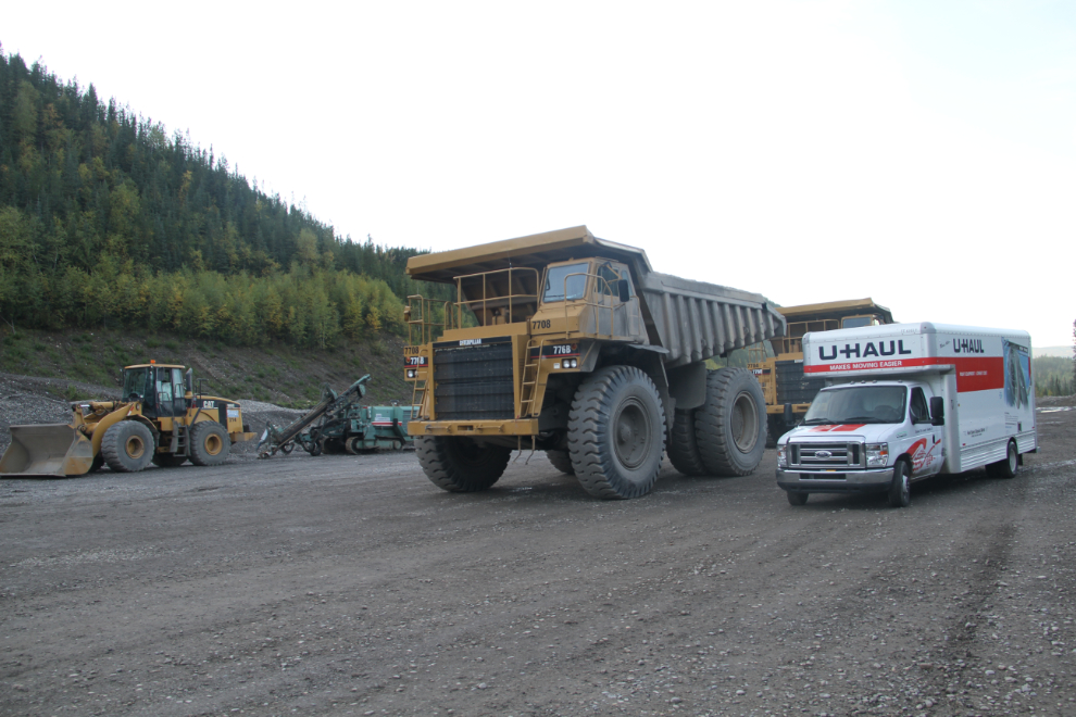 U-Haul truck beside a large dump truck