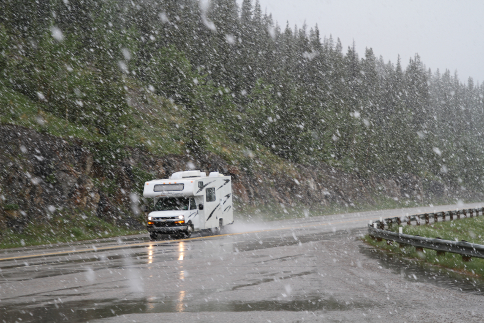 RV on snowy Alberta Highway 11 in June