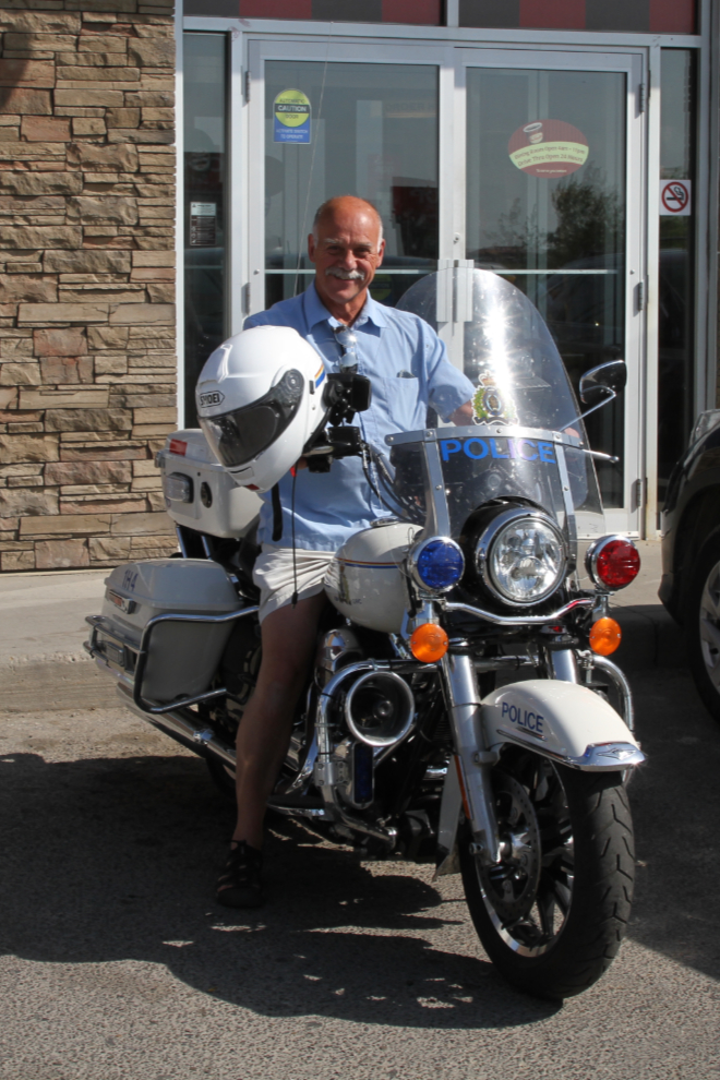 Murray trying on an RCMP motorcycle for size