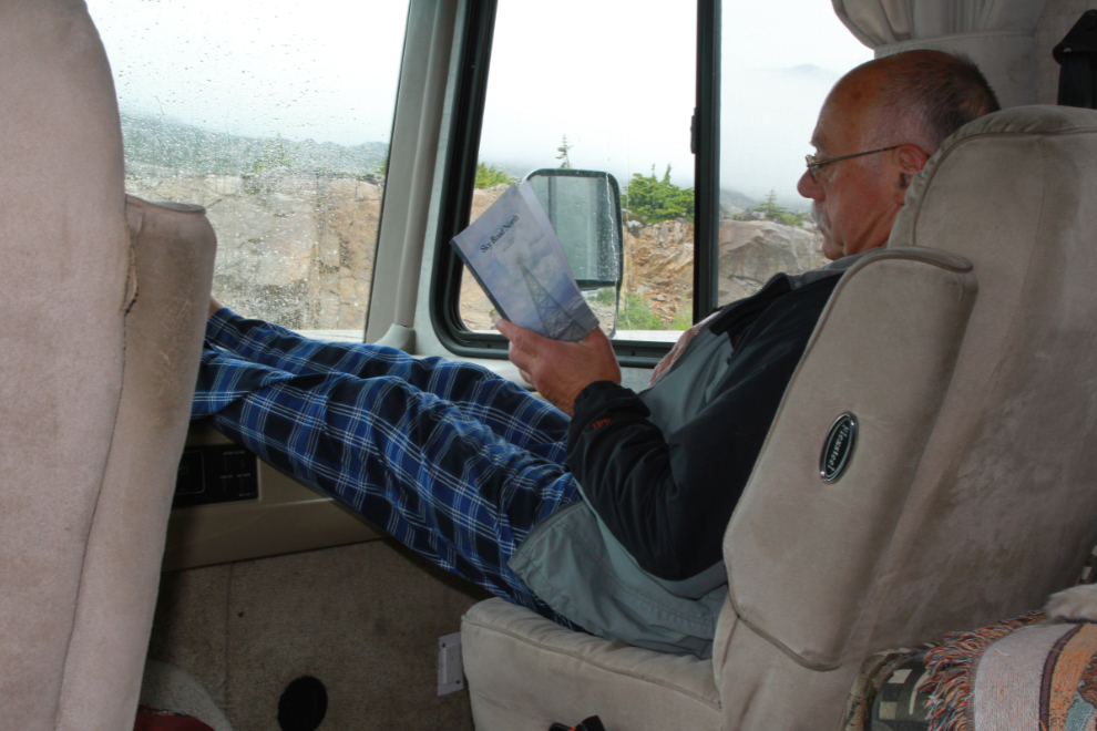 Murray Lundberg reading in his RV on a rainy evening