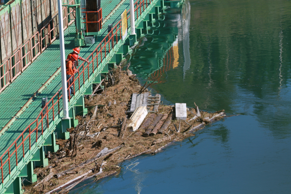 Debris including somebody's dock gathering at the Lewes River dam on the Yukon River