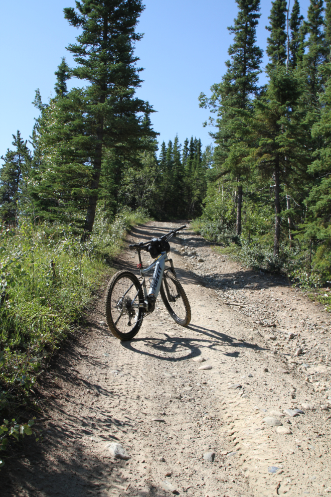 E-bike climbing the steepest hill on the Canol pipeline road