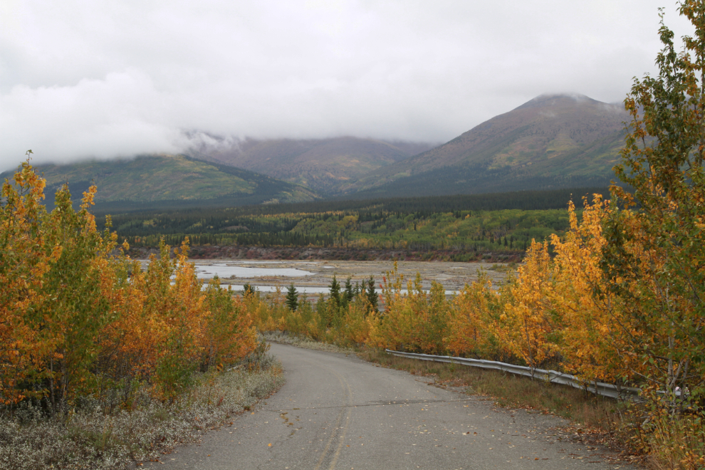 An abandoned section of Alaska Highway at Quill Creek leads down to the Kluane River. 