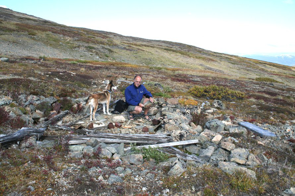 Murray Lundberg and his husky Monty at a historic mining camp on Montana Mountain, Yukon