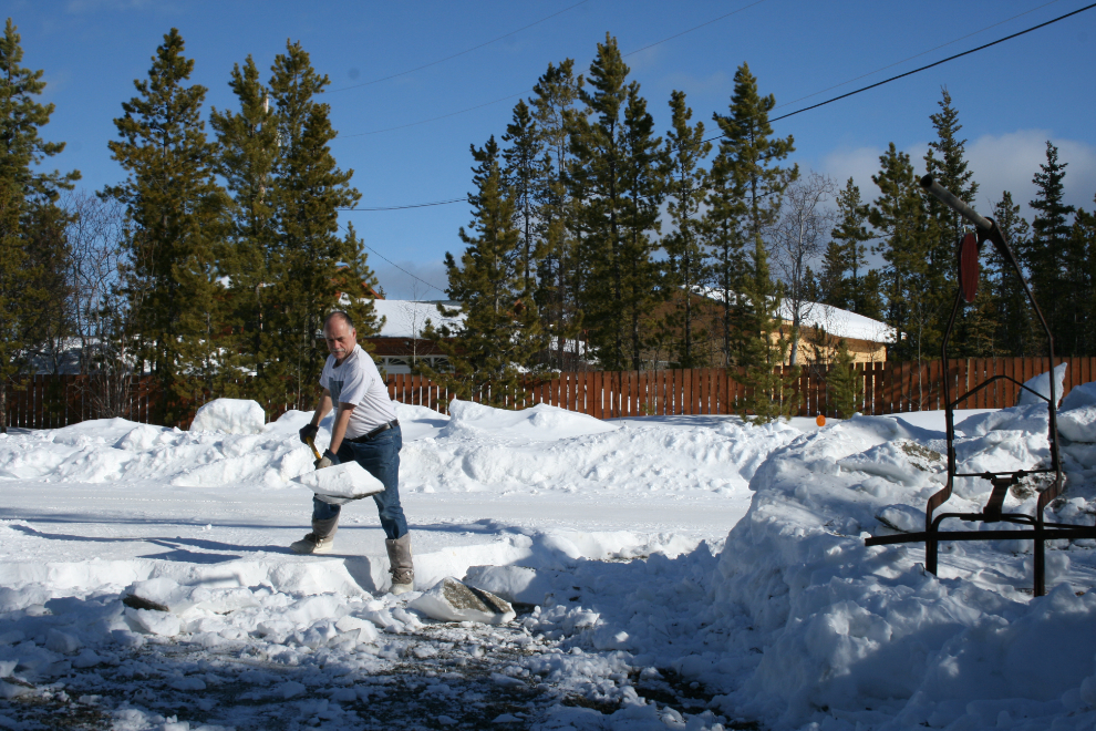 Shovelling a winter's accumulation of snow from the driveway
