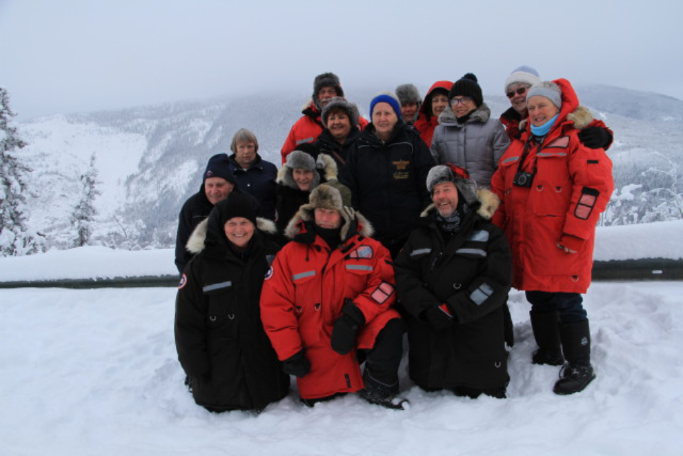 A winter tour group portrait overlooking Dawson City, Yukon