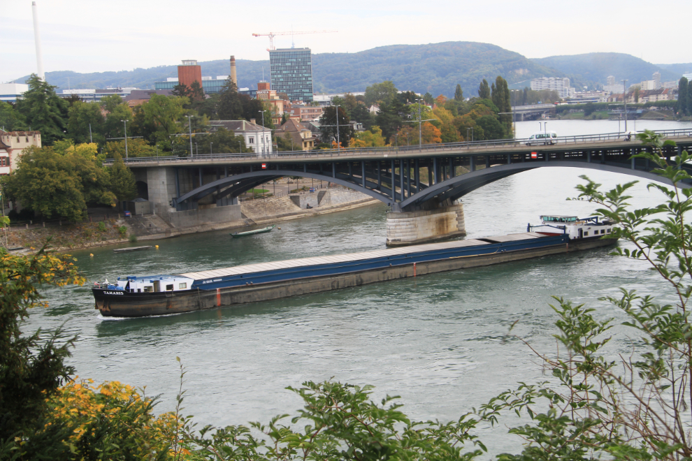 A large bulk carrier sails down the Rhine River in Basel, Switzerland