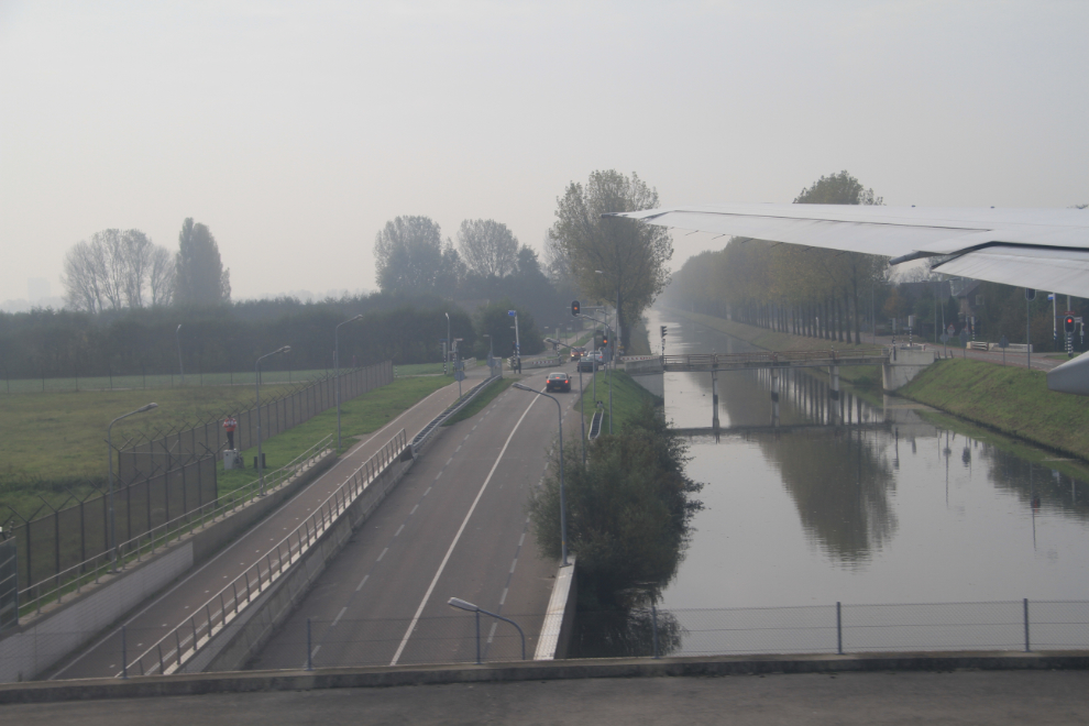 Taxiing over a road and canal at Schiphol airport, Amsterdam