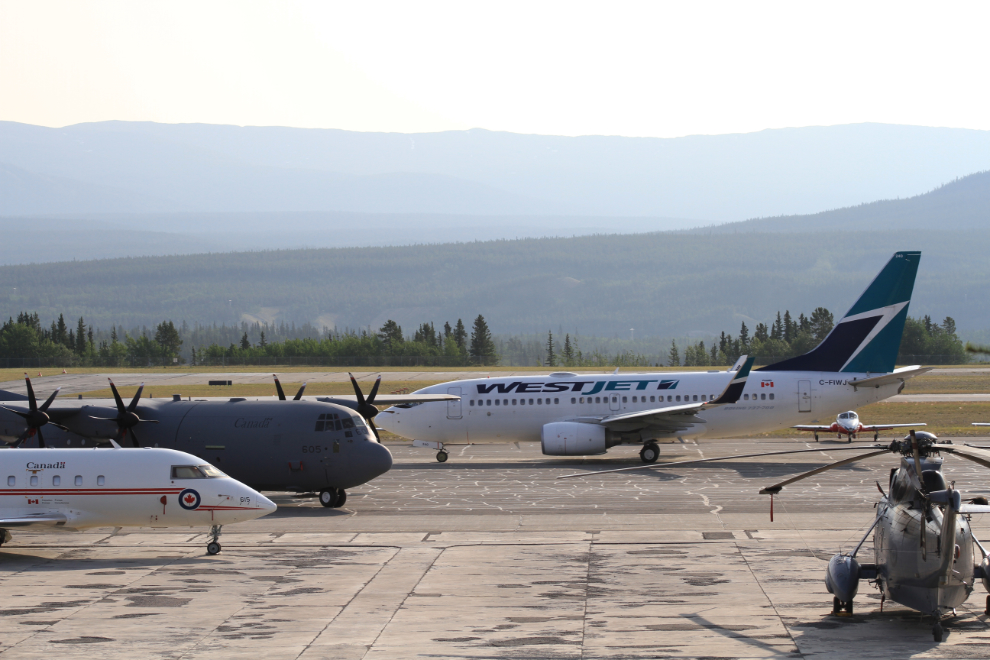 WestJet with military aircraft in Whitehorse