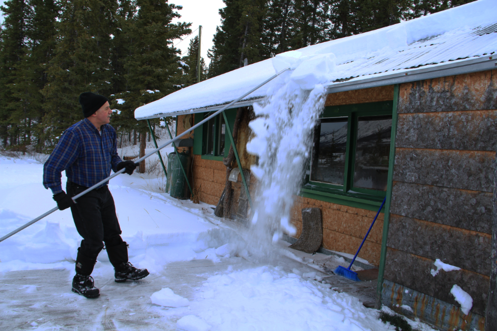 Clearing snow from the roof of the Carcross cabin