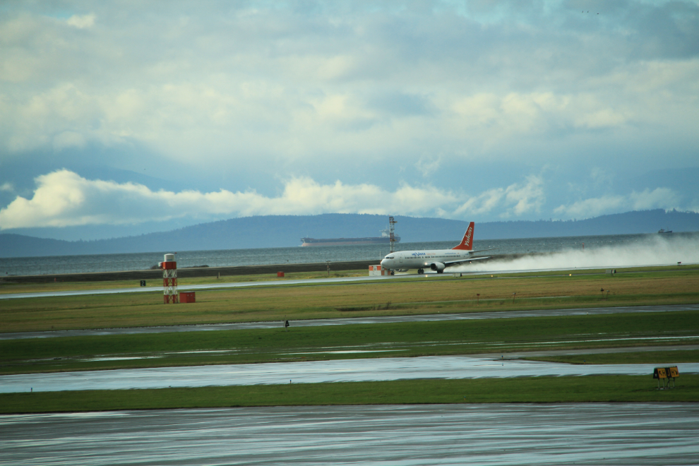 Air North's Boeing 737 C-FANB heads back home after a brief rain shower.