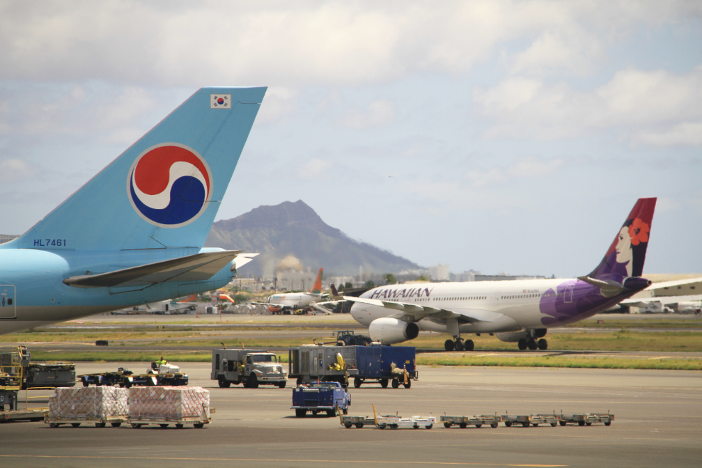 Honolulu Airport with a Hawaiian Airlines plane, and Diamond Head in the background