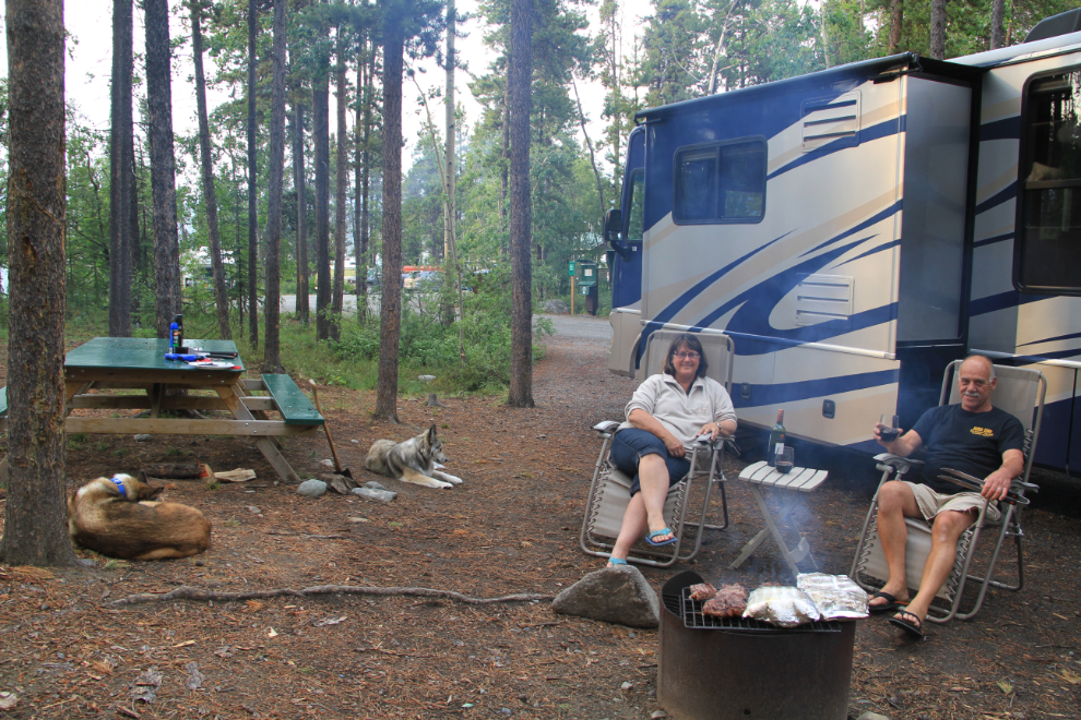 Cooking a steak dinner over the open fire at Squanga Lake Campground, Yukon