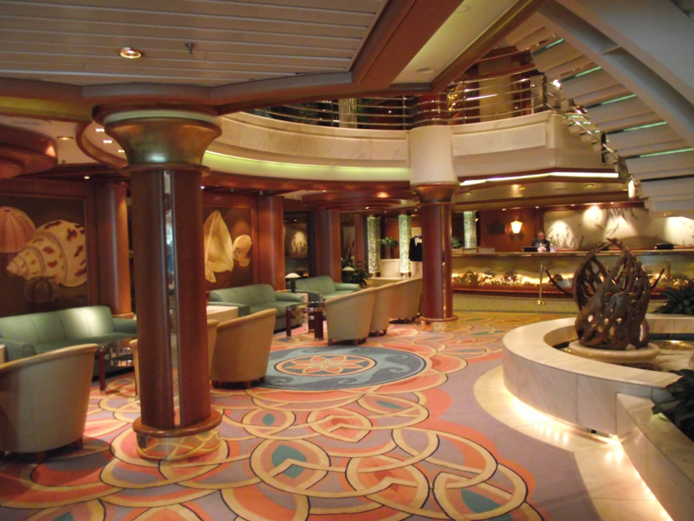 A corner of the atrium and the Guest Services desk on the Coral Princess
