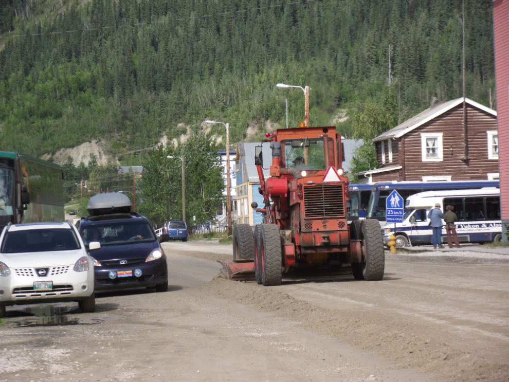 Grading 4th Avenue in Dawson City after heavy rains