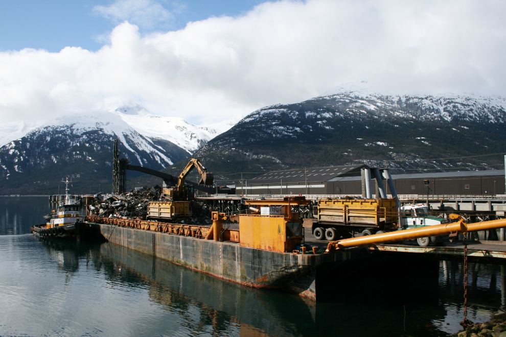 A barge being loaded with hundreds of tons of scrap metal at Skagway, Alaska