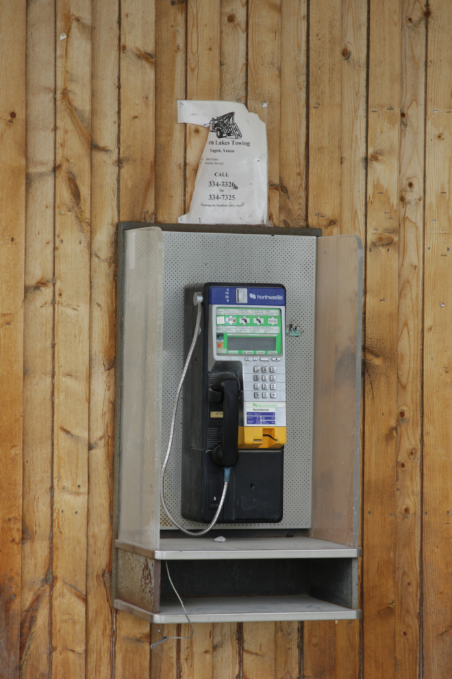 A pay phone on the wall of the lodge at Jake's Corner, Yukon