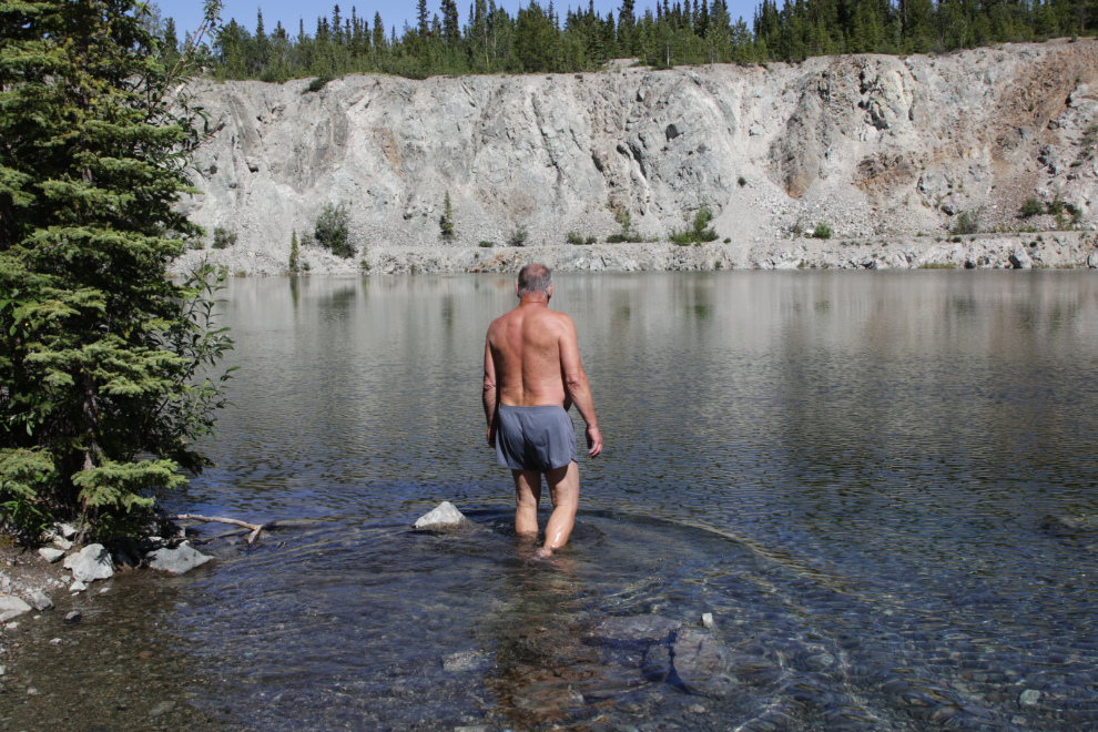Murray Lundberg going for a swim at the Keenenaw copper mine pit, Whitehorse Copper Belt, Yukon