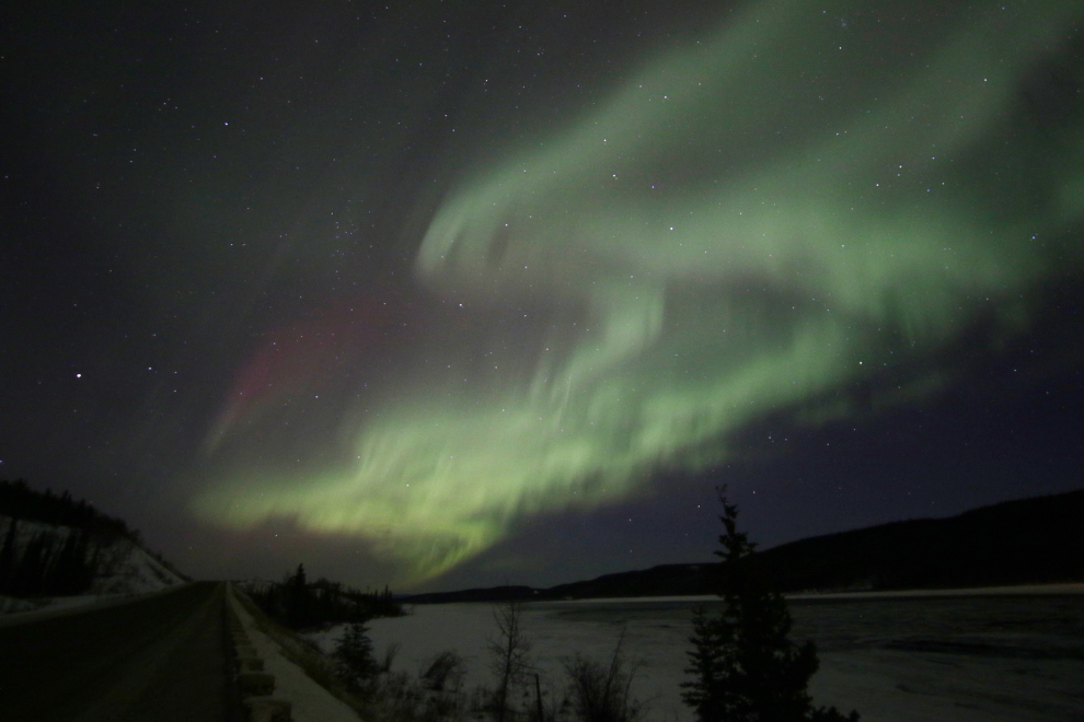 The aurora borealis over the Alaska Highway and Yukon River south of Whitehorse