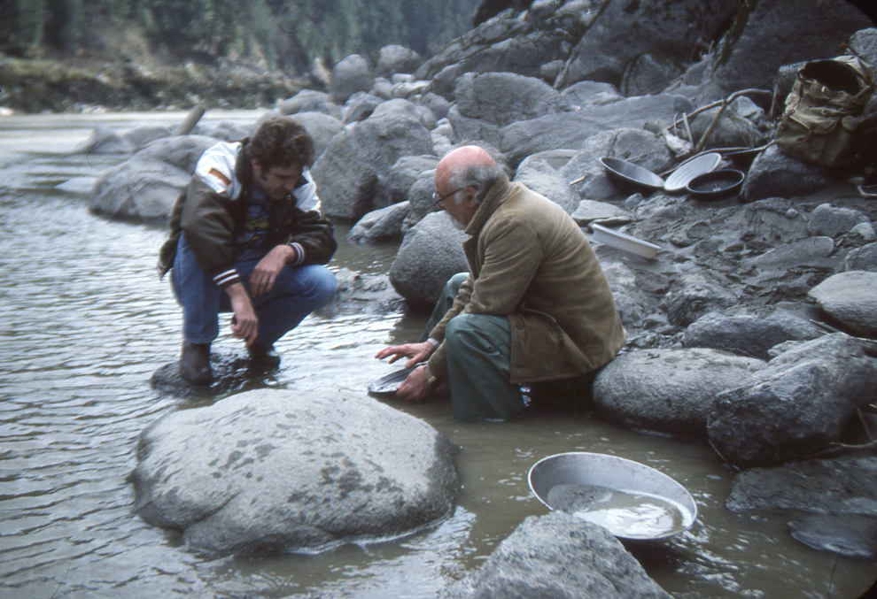 Dad on his placer gold claim on the Fraser River at Spuzzum, BC, showing a visitor how to pan for gold. 