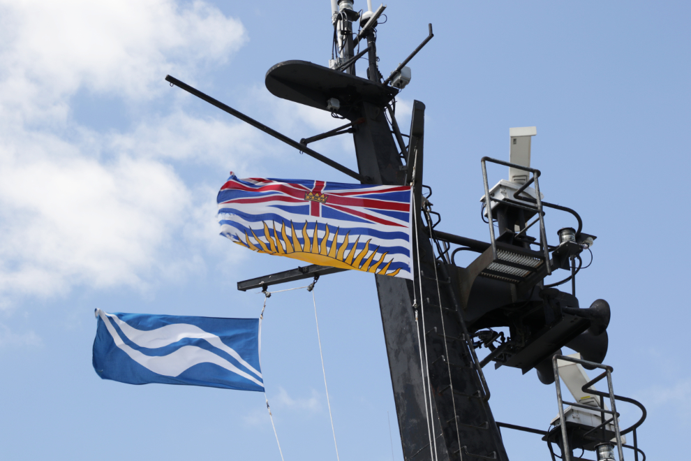 The flags of BC Ferries and the Province of British Columbia proudly flying in the sunshine.