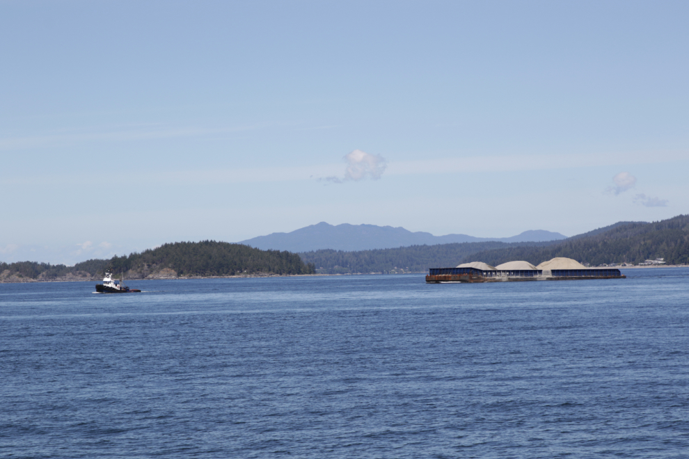 A tug towing barges of gravel at Davis Bay, Sechelt, BC.