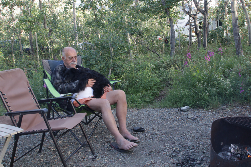 Snuggled with my puppy in front of the campfire at Conrad Campground, Yukon.