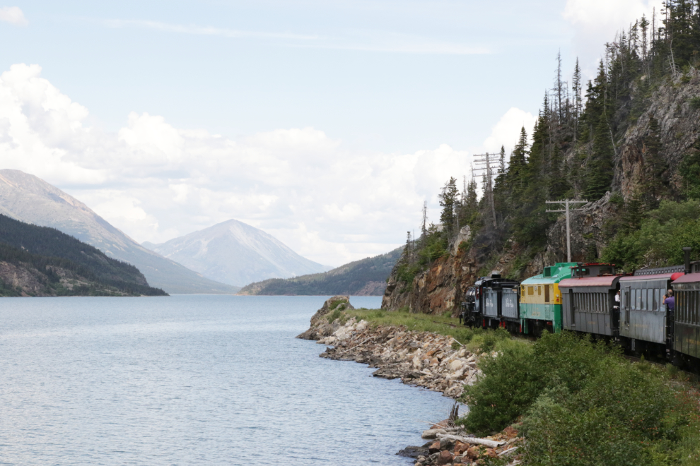 A WP&YR steam train along Lake Bennett, BC.