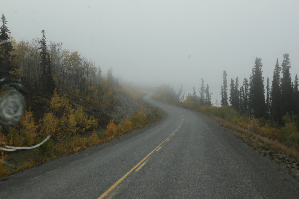 Driving along foggy Little Atlin Lake, Yukon.