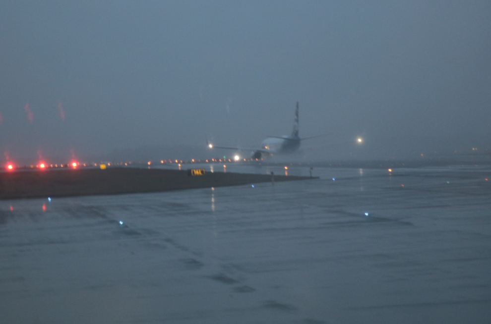 Alaska Airlines Boeing 737 taxiing at rainy Sea-Tac.