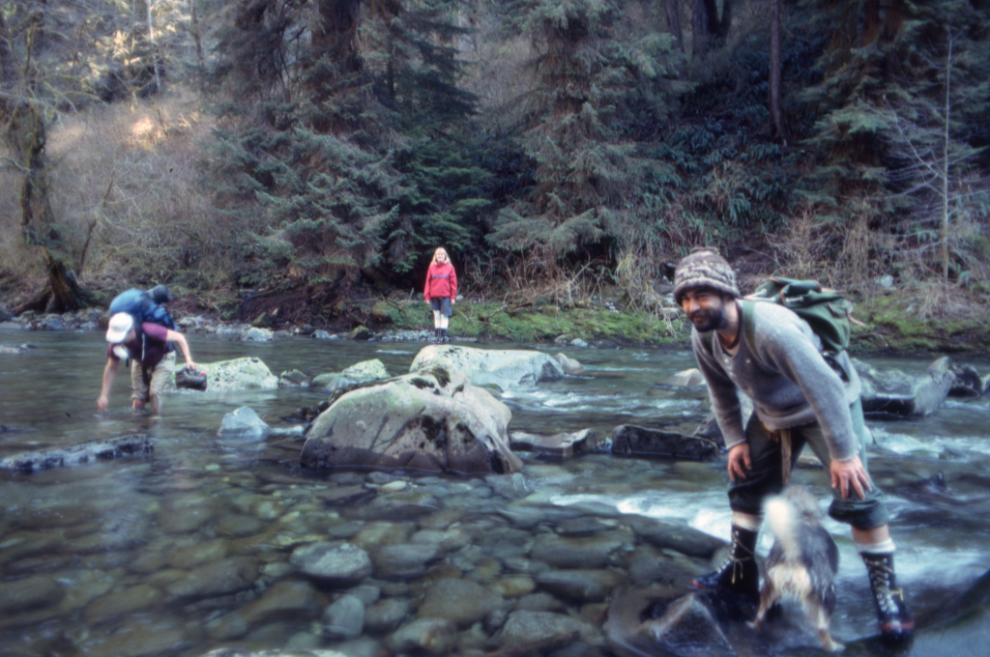 Lighthouse keeper Kurt Cehak, his girfriend (whose name I didn't record), and their two dogs on Carmanah Creek, 1990.