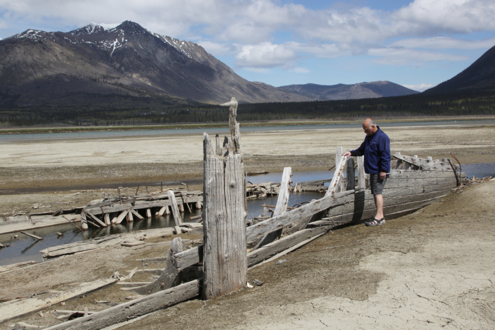 Murray Lundberg with the wreckage of the sternwheeler Gleaner at Carcross, Yukon.