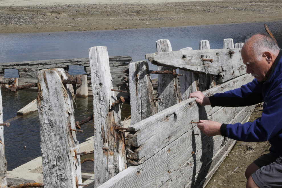 Murray Lundberg with the wreckage of the sternwheeler Gleaner at Carcross, Yukon.