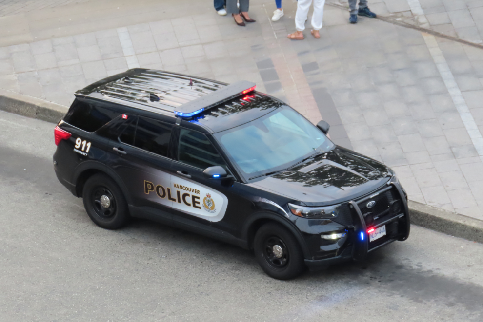 A Vancouver City Police car with lights flashing but nobody around.