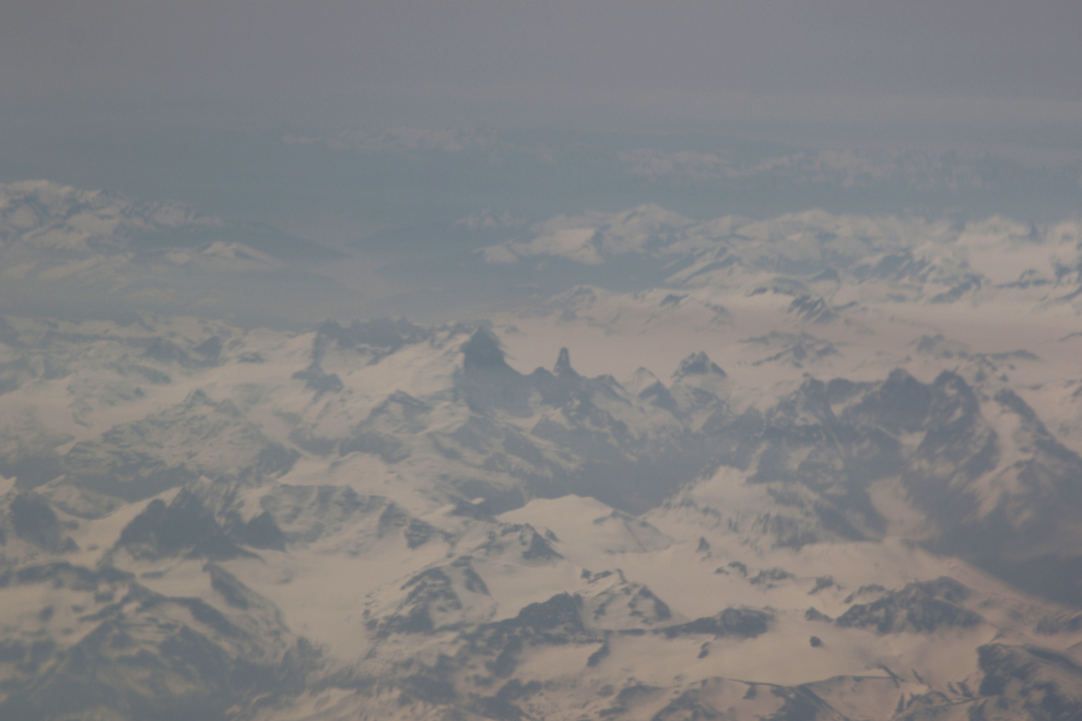 An aerial view of the incredibly rugged peaks between Atlin and Juneau, obscured by wildfire smoke.
